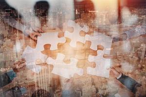 Teamwork of partners connect puzzle pieces as integration and startup photo