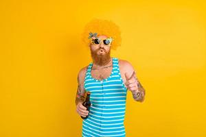 man with beard and sunglasses drinks beer photo