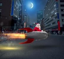 Santa claus delivers gifts with a fast space rocket photo