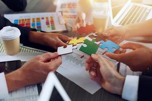 Teamwork of partners connect puzzle pieces as integration and startup photo