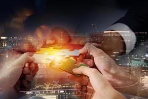 Teamwork of partners connect puzzle pieces as integration and startup photo