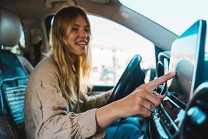 Woman selects the destination with car gps navigator photo