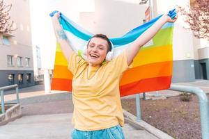 Happy woman with the peace flag is against the war and discrimination photo