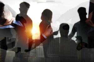 Handshaking business person in office. concept of teamwork and partnership. double exposure photo