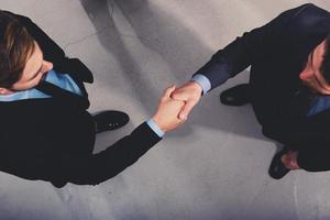 Handshaking business person in office. concept of teamwork and partnership photo