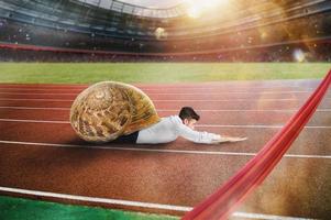 Businessman runs slow like a snail in a runner race photo