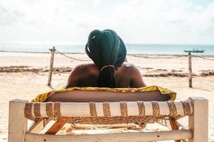 Person relaxing on the deckchair at sea photo