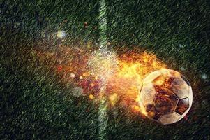 Powerful football kick of a soccer ball with flame of fire photo