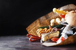 a can of beer with a snack on a wooden dark background . gift bouquet to a man. men's holiday gift photo