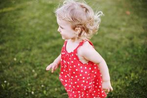 happy baby on green grass background smiling photo