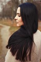 portrait of brunette woman with thick beautiful long hair close outdoor photo