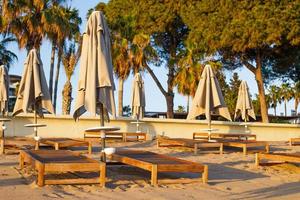 beach scene in Side Turkey with empty umbrellas and sun loungers. Vacation at the sea. Summer holidays. photo