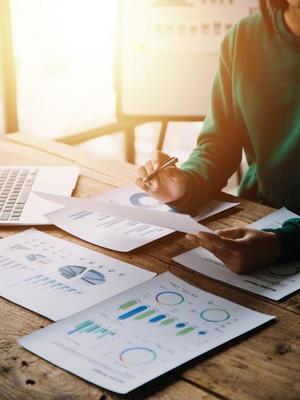Businesswoman or accountant working Financial investment on calculator, calculate, analyze business and marketing growth on financial document data graph, Accounting, Economic, commercial concept.
