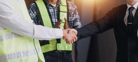 Two business man construction site engineer. Engineering objects on workplace with partners interacting on background photo