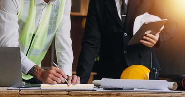 Architect concept, Architects working with blueprints in the office, Vintage Effect photo