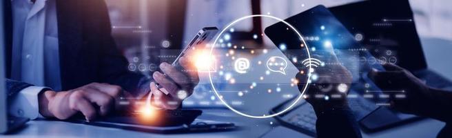 Contact us or Customer support hotline people connect. Businessman using a laptop and touching on virtual screen contact icons email, address, live chat, internet wifi. photo