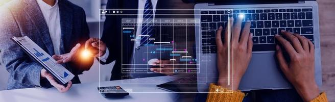 Project manager working with Gantt chart schedule to plan tasks and deliverables. Scheduling activities with a planning software, Corporate strategy for finance, operations, sales, marketing. photo