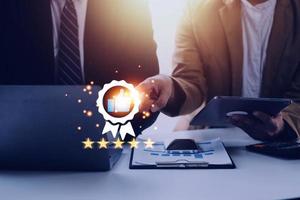 Hand shows the sign of the top service Quality assurance, Guarantee, Standards, ISO certification and standardization concept, satisfaction, service experience. photo