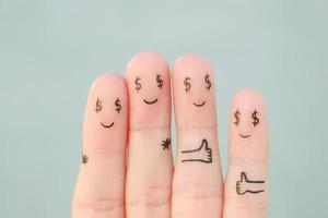 Fingers art of  happy family. Concept of man and woman having dollar sign instead of eyes. photo