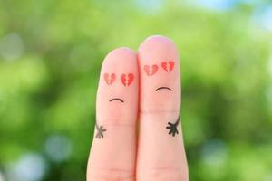 Fingers art of sad couple. Man and woman hug with broken hearts in eyes. photo