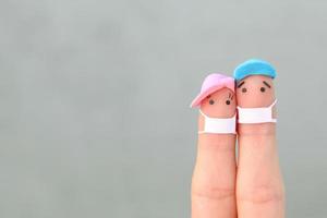 Fingers art of couple with face mask. Space for text. photo