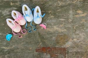 2022 new year written laces of children's shoes and pacifier on old wooden background. Top view. Flat lay. Space for text. photo