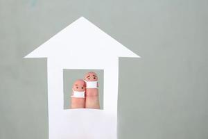 Fingers art of couple with face mask at home. photo