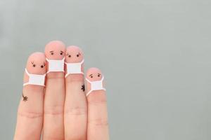 Fingers art of family with face mask. photo