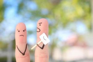 Fingers art of family during quarrel. Concept of people hiding emotions. Husband shouts on wife. photo