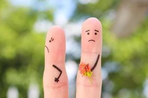 Fingers art of couple. Man gives a woman a bouquet of flowers, she is not satisfied. photo