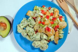 Chicken salad with spinach and crispy potatoes dressed with olive oil, garlic, lemon, onion and thyme photo
