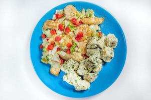Fried potatoes with bacon and green onion on wooden background, top view. photo