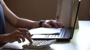 Side view of male hand using a calculator to calculate the first quarter of the year,Advertising shooting concept video