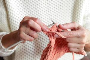 Close up of hand knitting from yarn photo