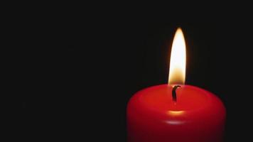 Red candle on a dark background burns of the dead people who died in the war, from illness. Memorial Day, Veterans Day video