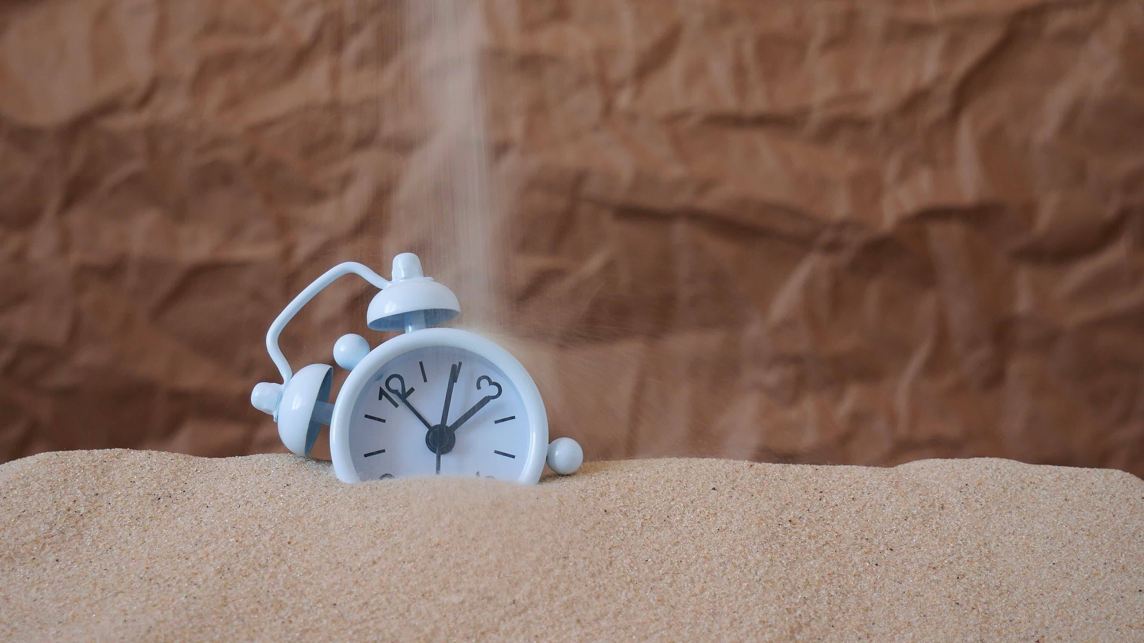 Sand falls on the clock. Countdown, the flow of life. The Concept Of