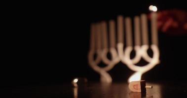 Hanukkah traditions with a menorah and two dreidels video