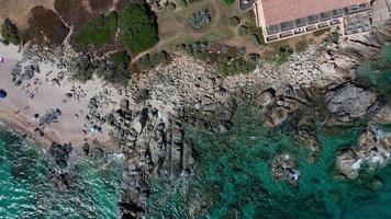 Aerial top down view of sea coast with rocks and beach video