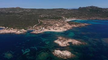 Aerial view of a beach and sea coast with small rocky island video