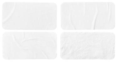 Set of four crumpled paper sheets, each of which is isolated on white background. Rectangle shape has rounded edges. Template mockup photo
