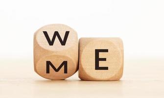 From Me to We concept. Flip wooden cube blocks with text on table photo