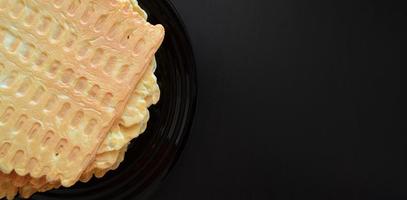 dark wooden background with waffles, plate with homemade cakes, belgian waffles photo