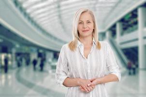 Attractive middle aged business woman with folded arms. photo