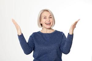 Attractive middle aged woman with folded arms on white background photo