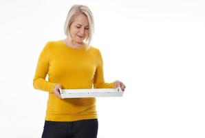 Kitchen woman gives empty tray for your advertising products isolated on white background. Mock up for use photo