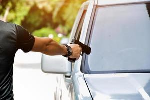 9mm automatic pistol holding in right hand of shooter, concept for security, robbery, gangster, bodyguard around the world. selective focus on pistol. photo