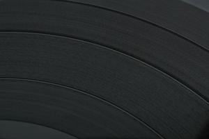 Close up of black old vinyl record play disc vintage with copy space for text. Retro LP history, nostalgia concept. Sound technology for DJ to mix music. Flat lay, top view photo