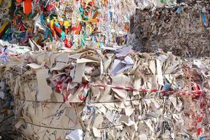 Stack of cardboard carton packed pile prepare for recycling on plant. Eco-friendly lifestyle zero waste concept. Environmental conversation technology. Garbage sorting. Ecology reuse green world idea. photo