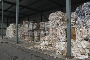 Wastepaper compact texture pile for recycling on sorting plant. Technology of reuse materials. Stack of shredded paper. Save the planet ecology concept. Industry of reduced pollution factory. Close-up photo