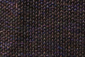 Woven dark wool fabric texture. Hand knitted textile canvas background. Patchwork carpet backdrop. Factory material threads. Abstract design. Close-up, mockup, top view photo